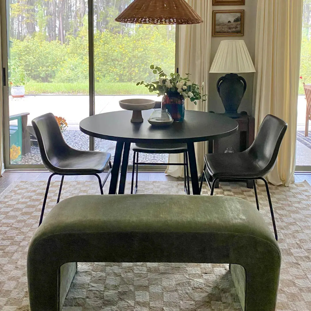 Lily Chenille Accent Waterfall Bench in modern dining room with black table and chairs, beige carpet.