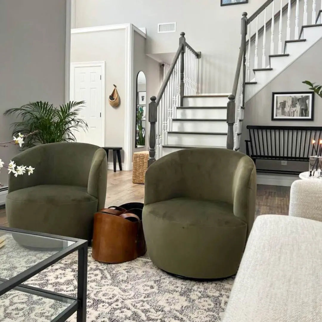 Bella Modern Olive Velvet Swivel Barrel Chairs in elegant living room with neutral decor and stairs.