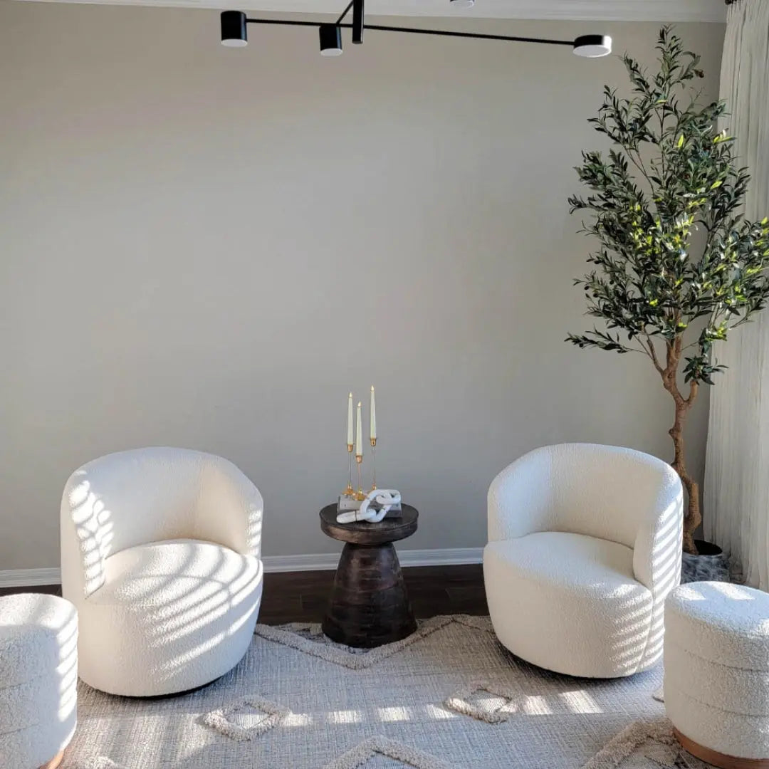 Bella Modern White Boucle Swivel Barrel Chairs in living room, dark wood floor, neutral rug.