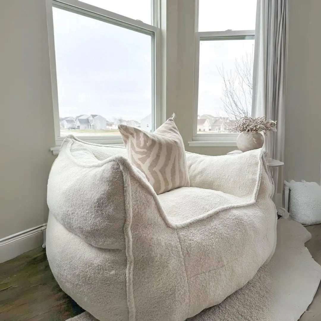 Boring Upholstered Teddy Bean Bag Chair in cozy living room, light walls, wood flooring.