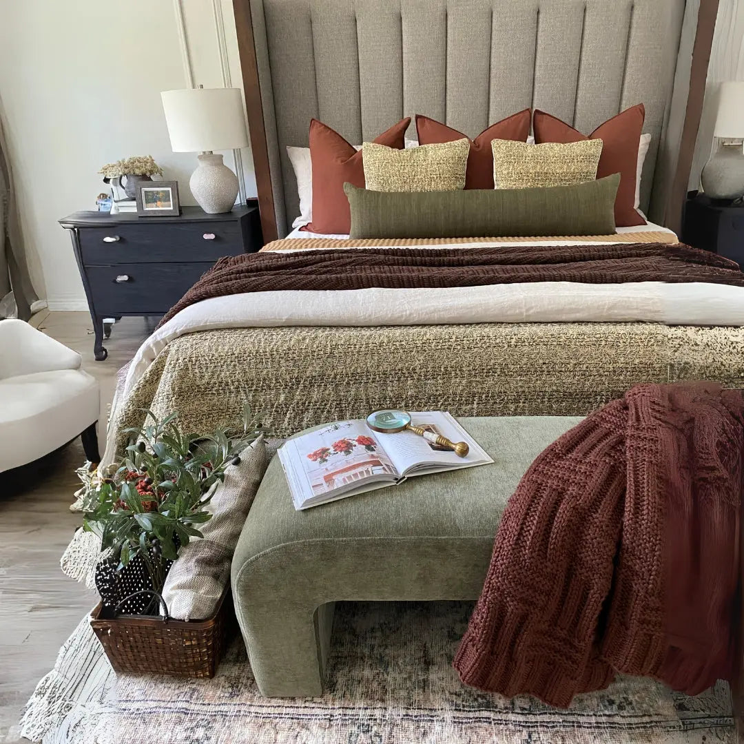 Lily Chenille Accent Waterfall Bench in bedroom with grey headboard, dark nightstands, hardwood floors.