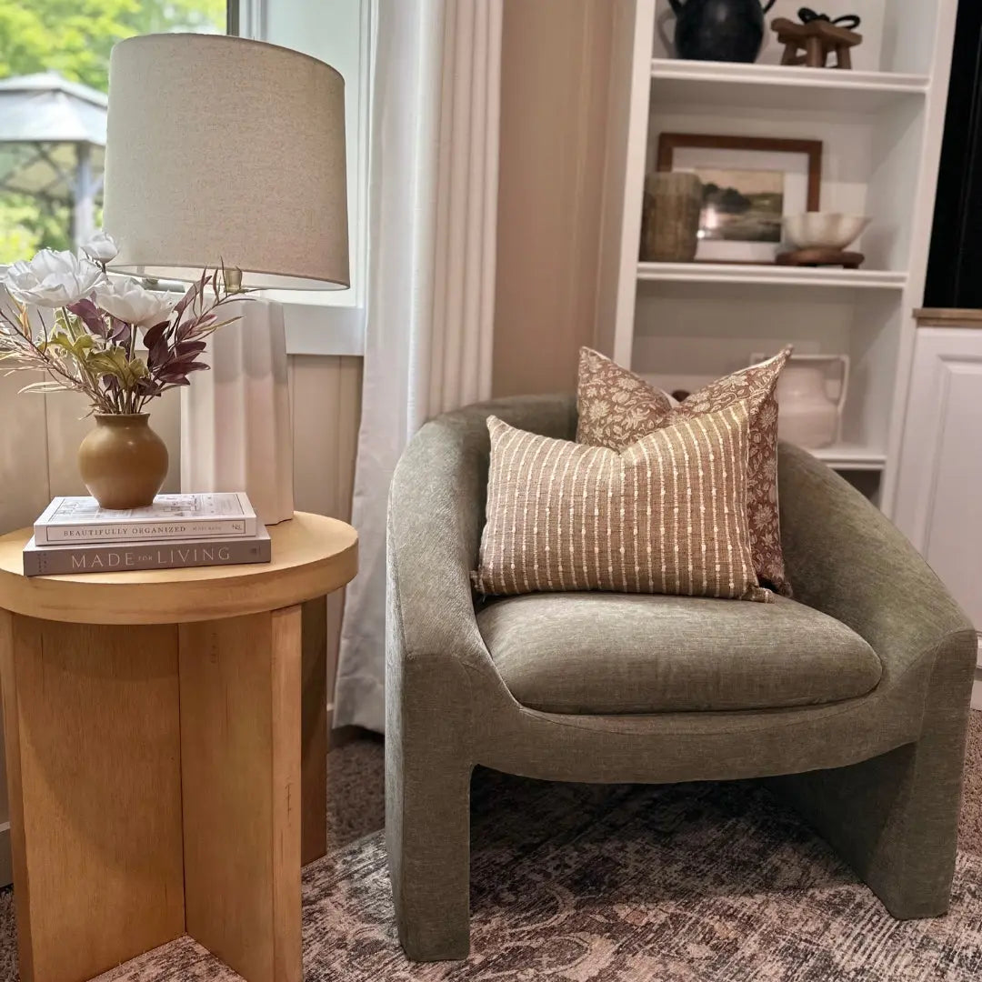 Kiki Modern Chenille Boucle Accent Chair, wooden side table, neutral decor, and white bookshelves.