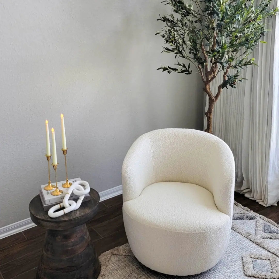 Bella Modern White Boucle Swivel Chair in cozy living room with dark wood flooring, light gray walls.