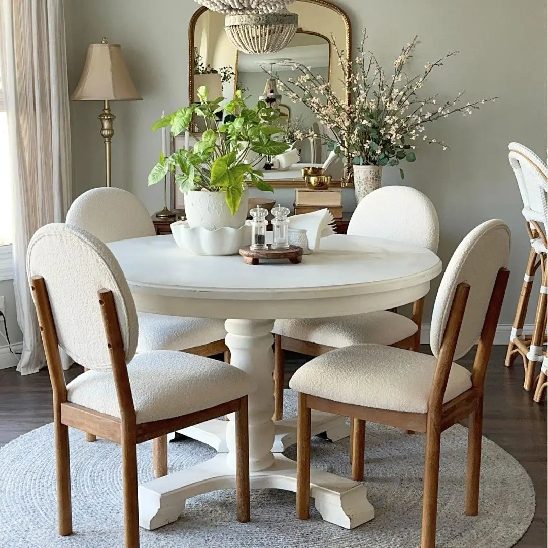 Maye Boucle Beige Dining Chair in elegant room with white table, soft gray walls, round rug.