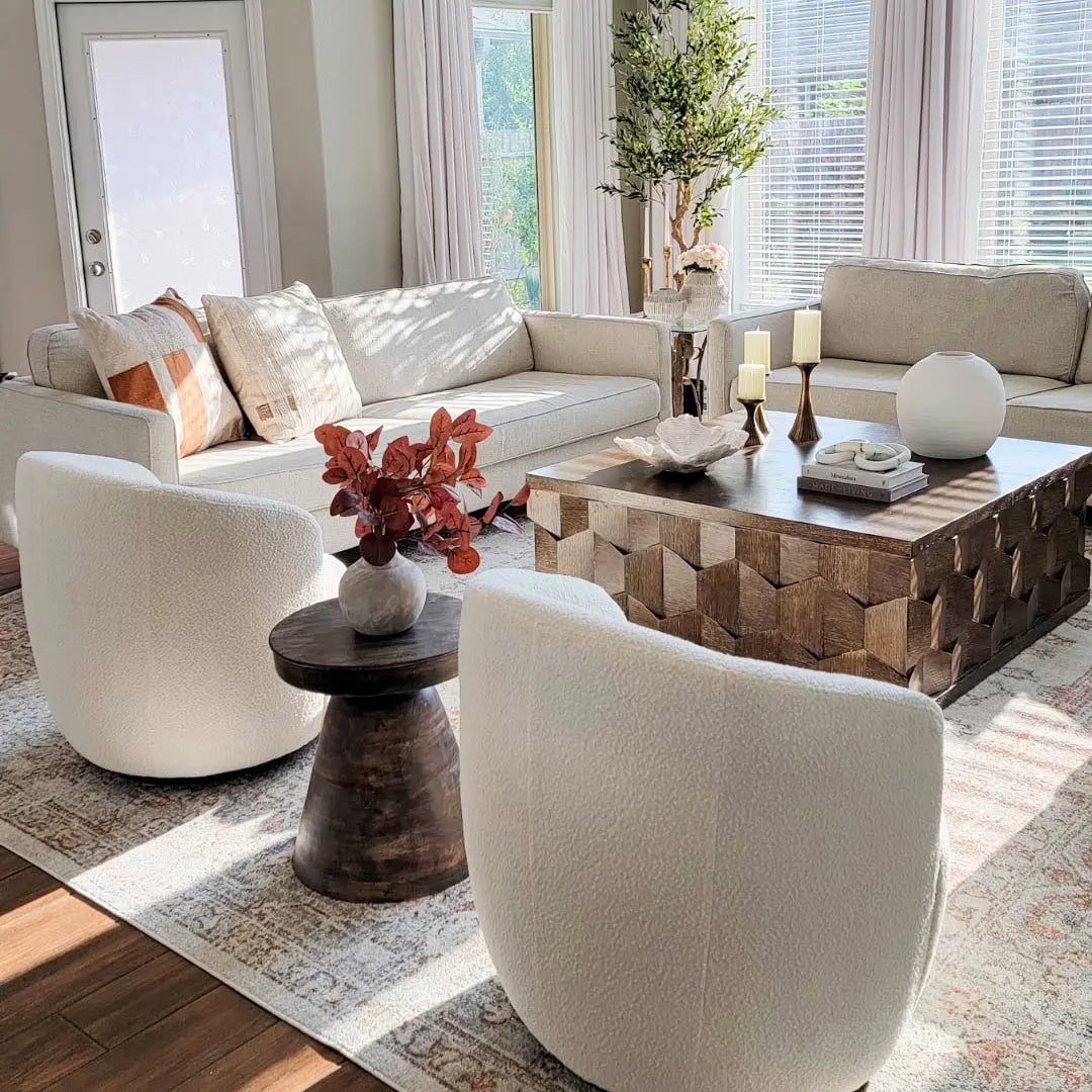 Bella white boucle swivel chairs in modern living room with beige sofa, wooden coffee table.