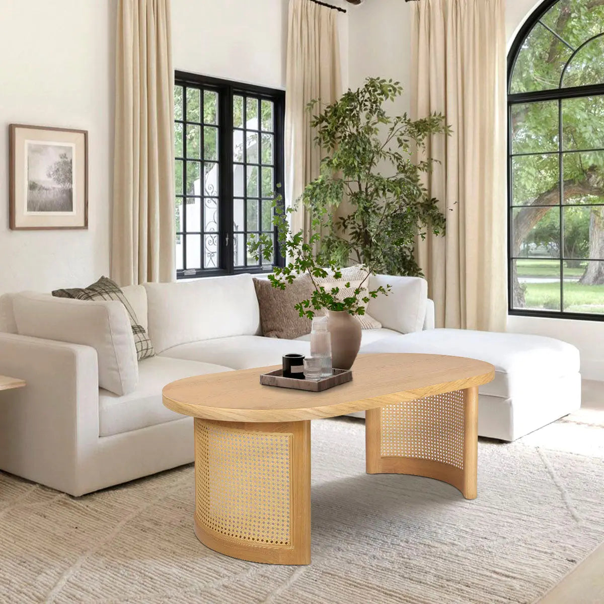 Aodai Oak Wood Rattan Oval Coffee Table in cozy living room with white sofa and beige curtains.