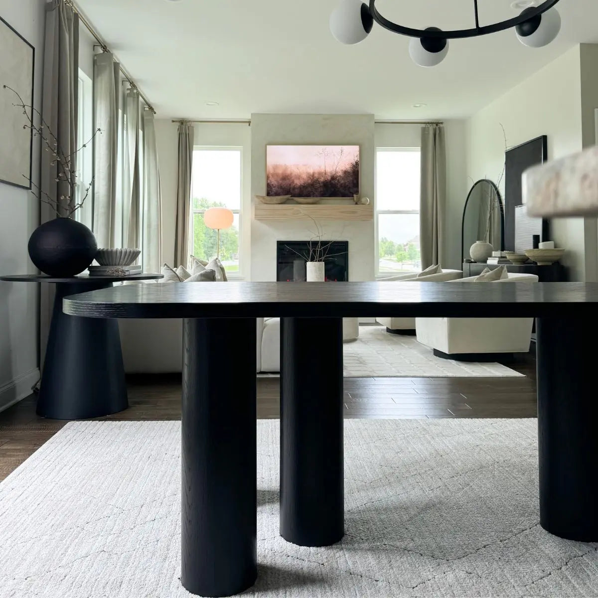 Rectangle oak dining table in modern living room; white sofa, dark flooring, elegant decor.