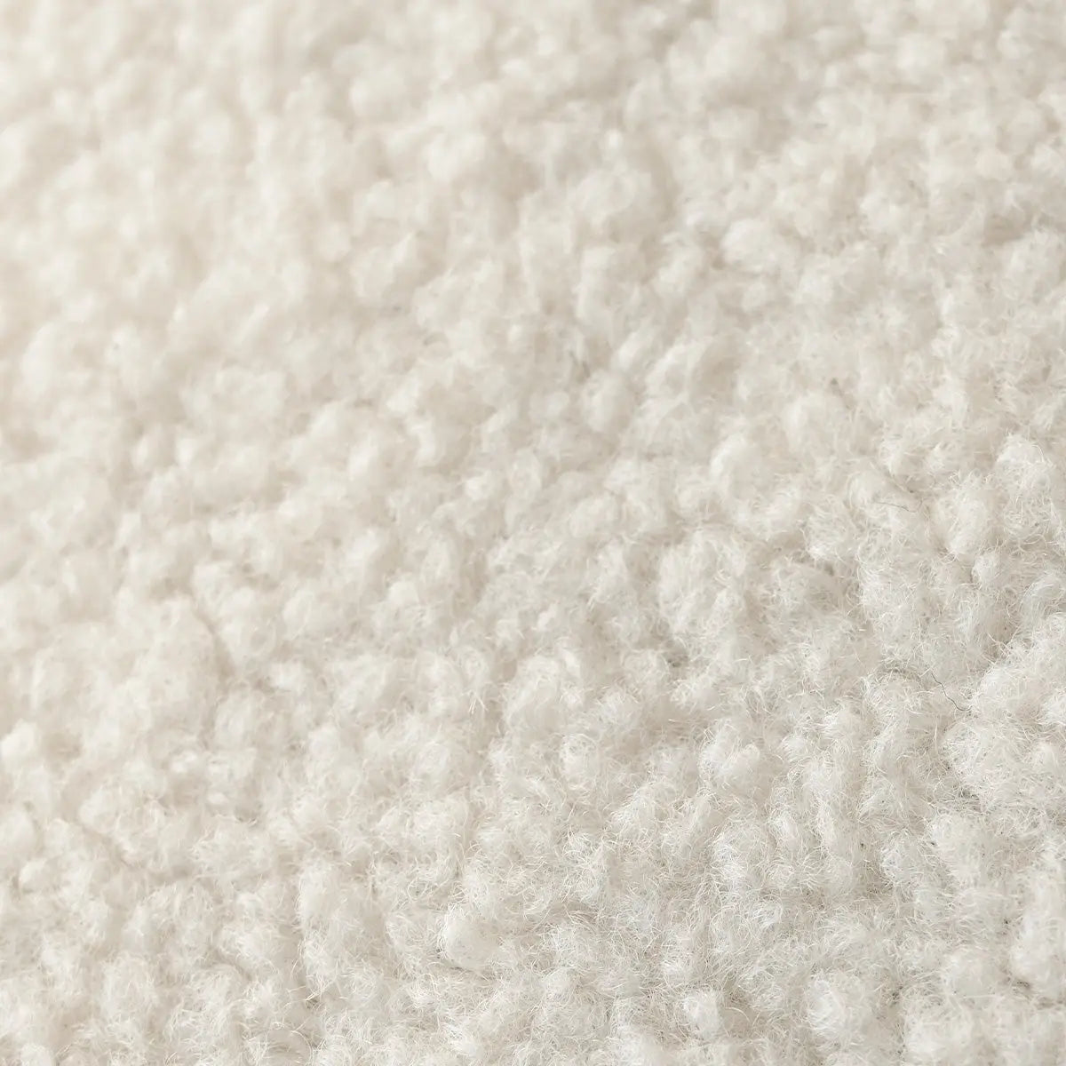 Close-up of cozy Teddy fabric from Boring Upholstered Bean Bag Chair, showcasing soft texture.