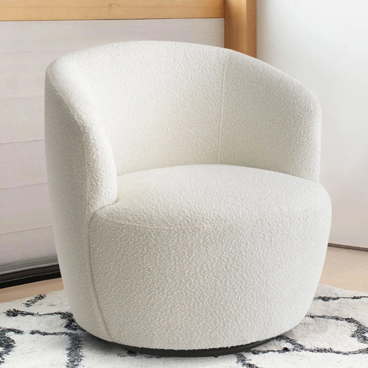 Bella Modern Boucle Swivel Barrel Chair on patterned rug; light wooden wall, beige tone room.