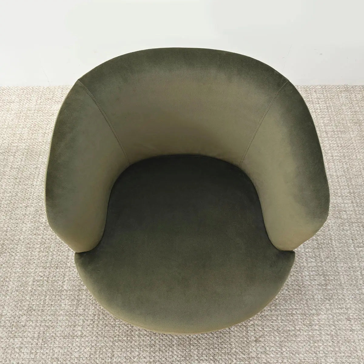 Bella Modern olive green velvet swivel barrel chair with textured carpet in neutral room setting.