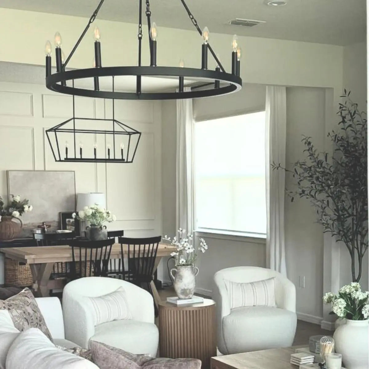 Modern living room with Bella Swivel Barrel Chairs, white walls, wooden flooring, and stylish decor.