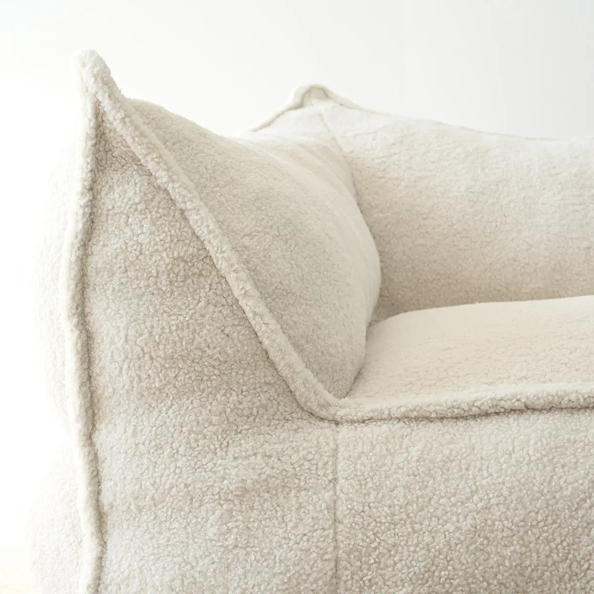 Boring Teddy Fabric Bean Bag Chair in soft cream color, showcasing textured upholstery design close-up.