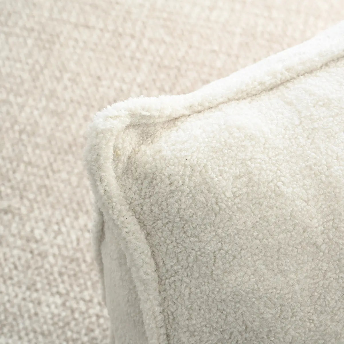 Close-up of Boring Teddy Fabric Bean Bag texture in a living room with plush beige textiles.