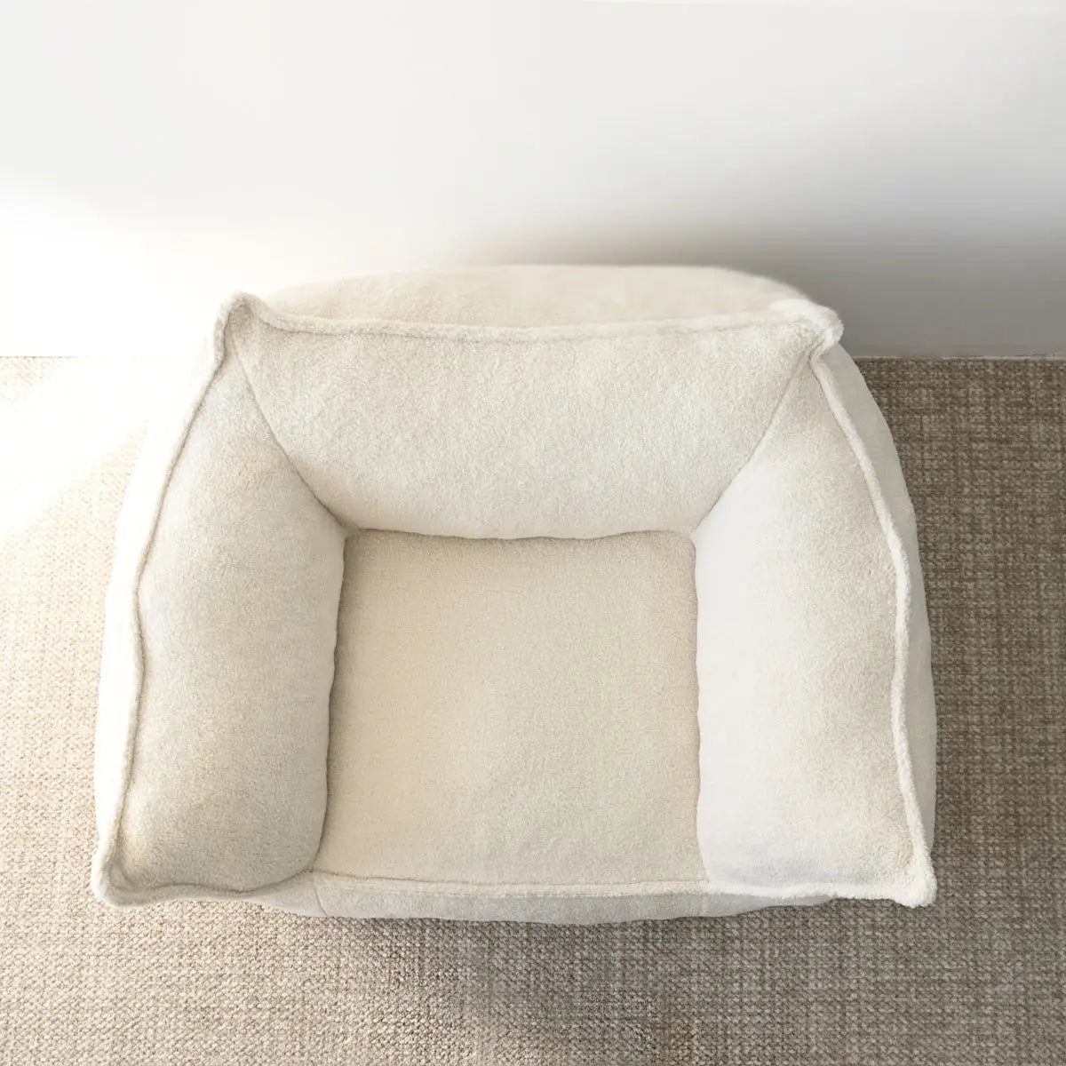 Boring Upholstered Teddy Fabric Bean Bag Chair on textured carpet, beige wall backdrop.