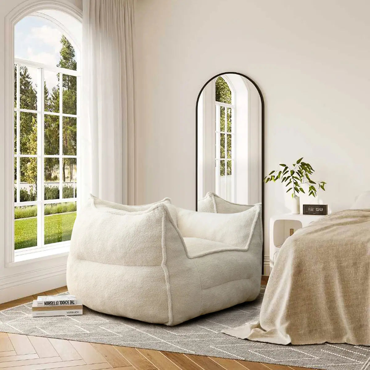 Creamy upholstered bean bag chair in cozy bedroom with hardwood floors, large mirror, and soft lighting.