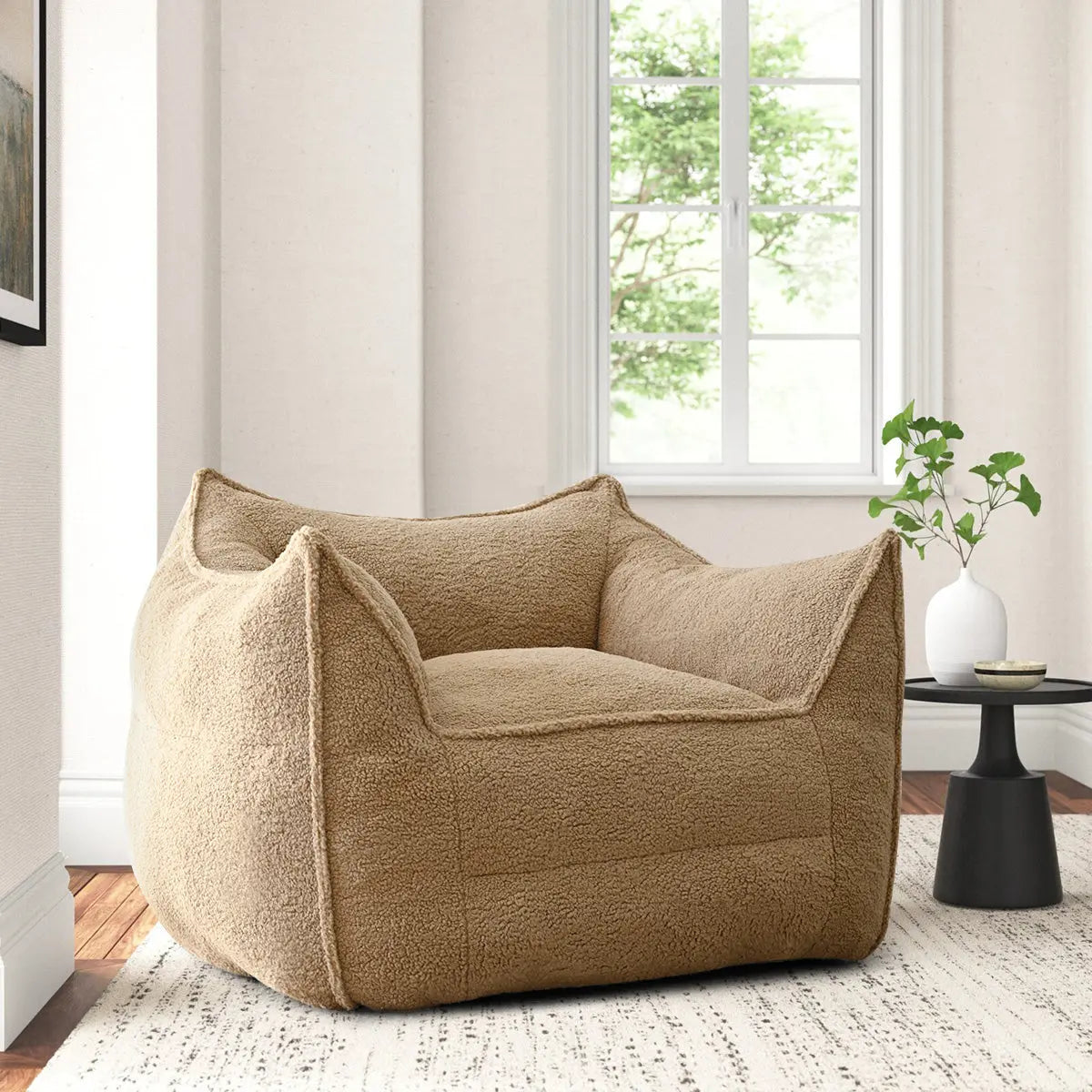 Boring Teddy Fabric Bean Bag Chair in cozy room with white walls, wooden floor, rug, side table.