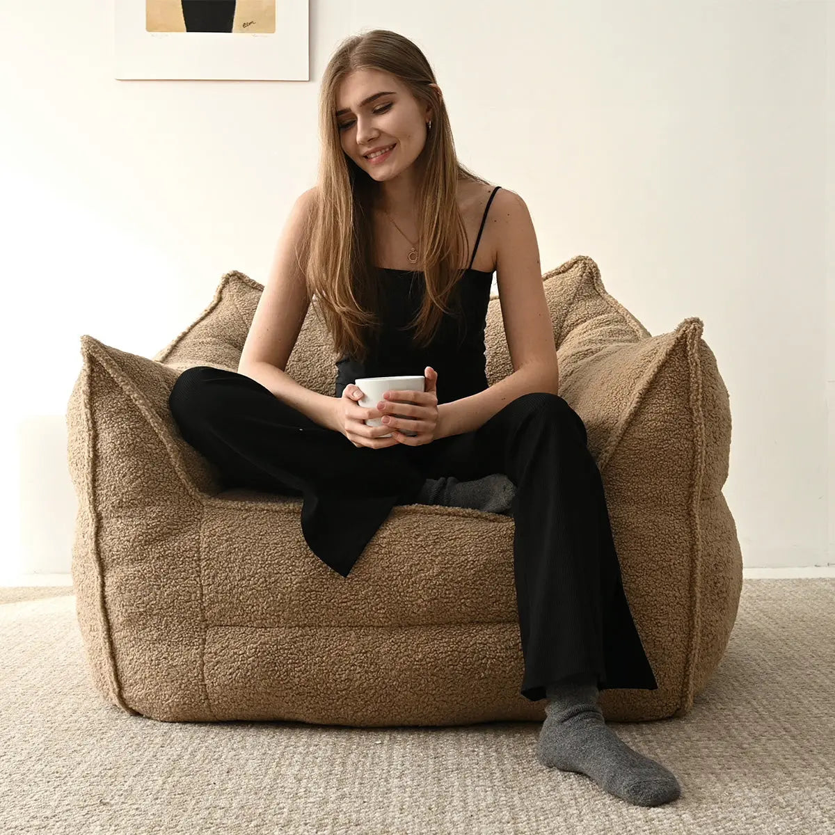 Boring Teddy Fabric Bean Bag Chair in cozy living room with neutral carpet and wall art.