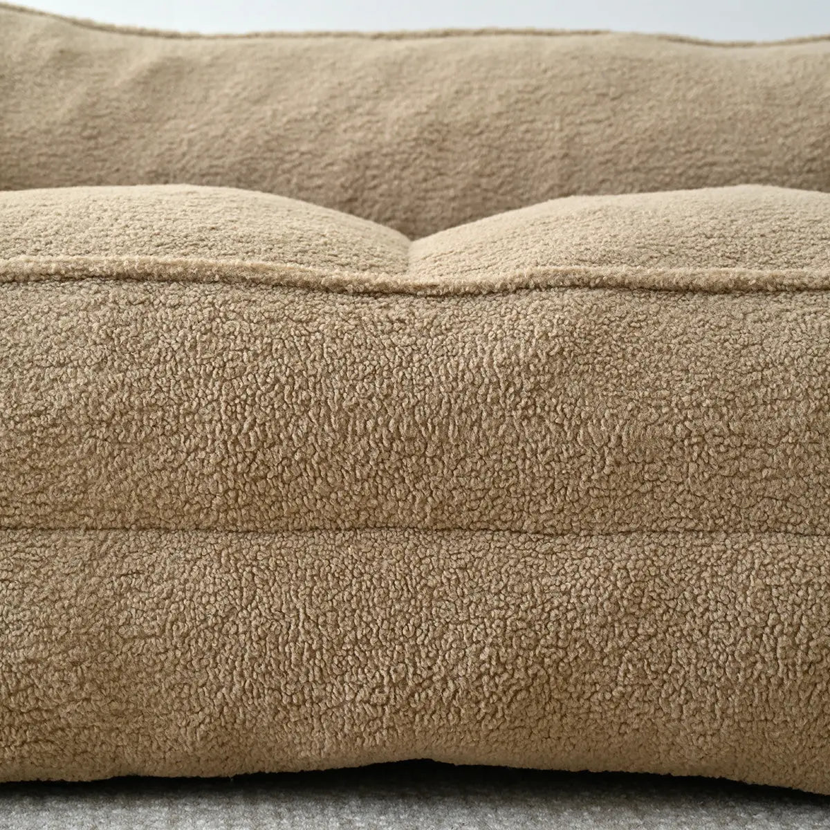 Boring Large Teddy fabric bean bag loveseat sofa, beige color, close-up on textured fabric.