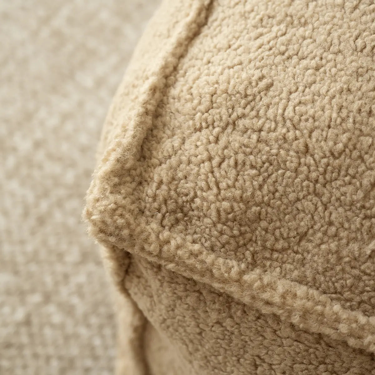 Close-up of beige Boring Teddy Fabric Bean Bag Chair texture in living room setting.