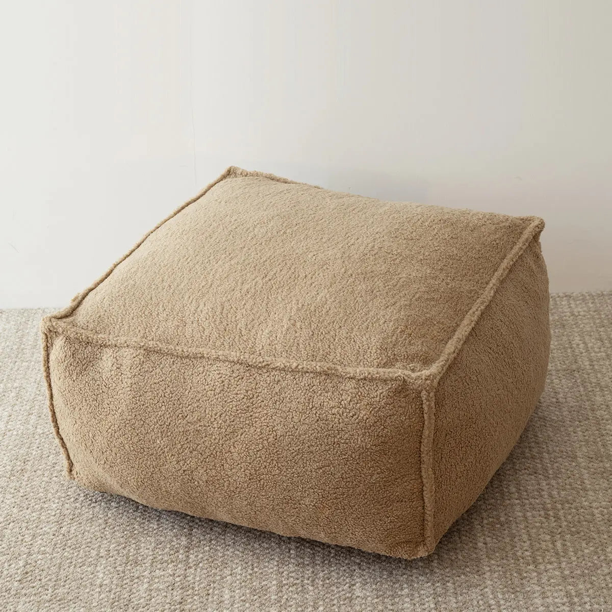 Boring Teddy Fabric Bean Bag Chair on gray carpet, beige wall, cozy room setting.