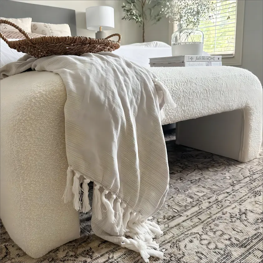 Lily Modern Velvet Accent Waterfall Bench, neutral bedroom, plush gray headboard, patterned rug flooring.