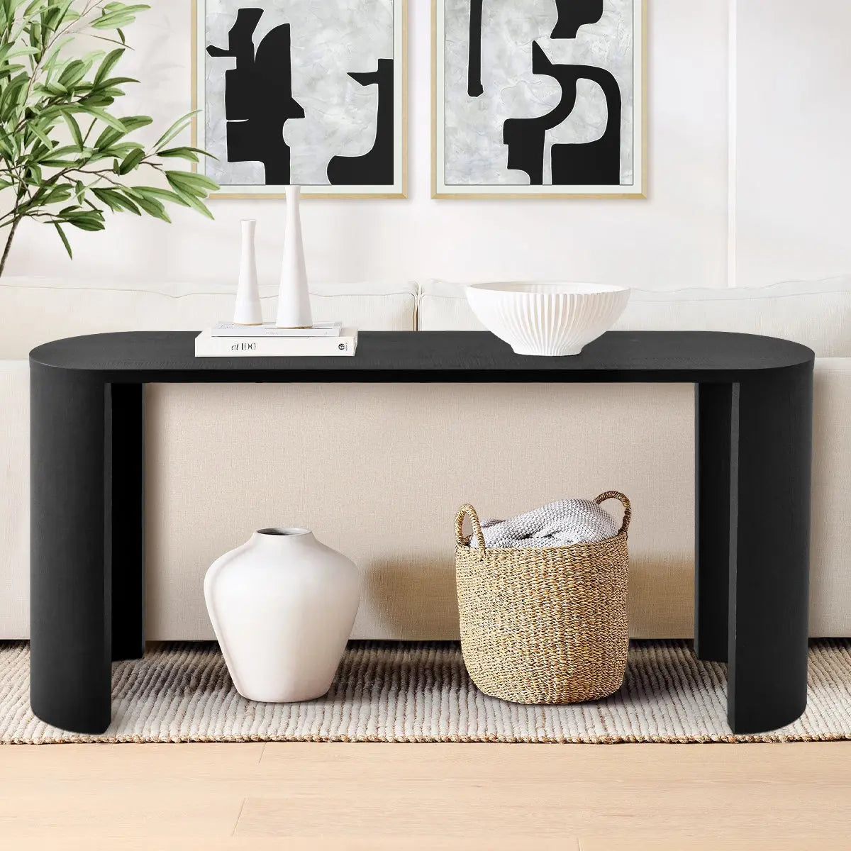 Dwen Modern Oval Console Table in beige room with abstract art and neutral sofa, hardwood flooring.