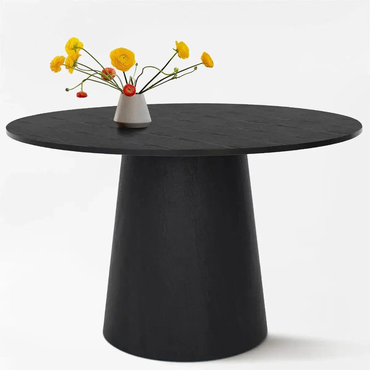 The Dwen Modern Round Pedestal Dining Table with black finish and yellow flowers.