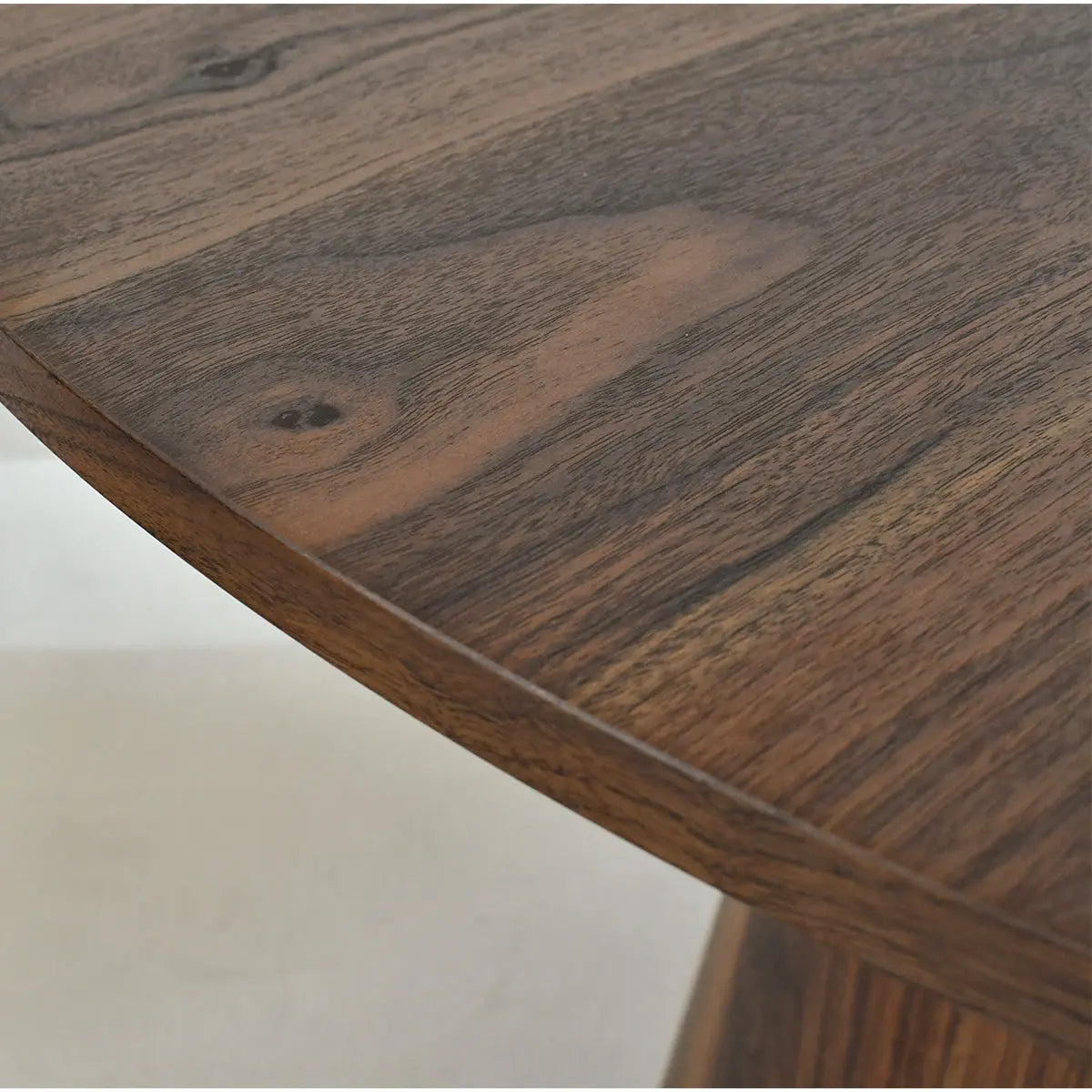 Close-up of Dwen Modern Round Dining Table with natural wood grain texture; pedestal design visible.