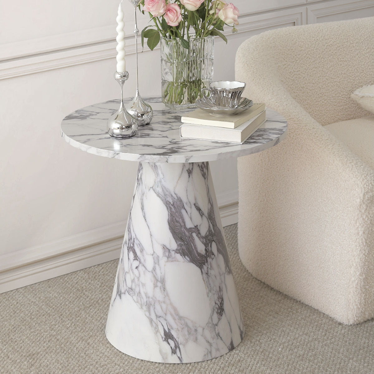 Dwen Marble Round Pedestal Side Table in living room with cream sofa and carpet flooring.