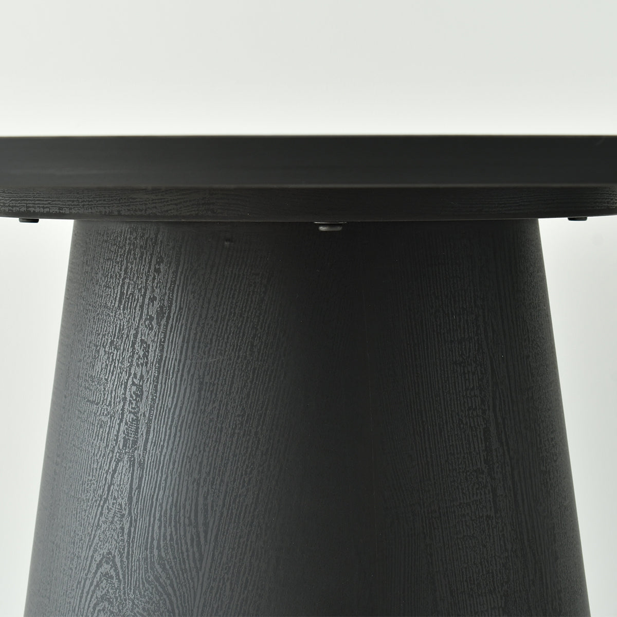 Close-up of black wood texture on Dwen Modern Round Pedestal Dining Table.