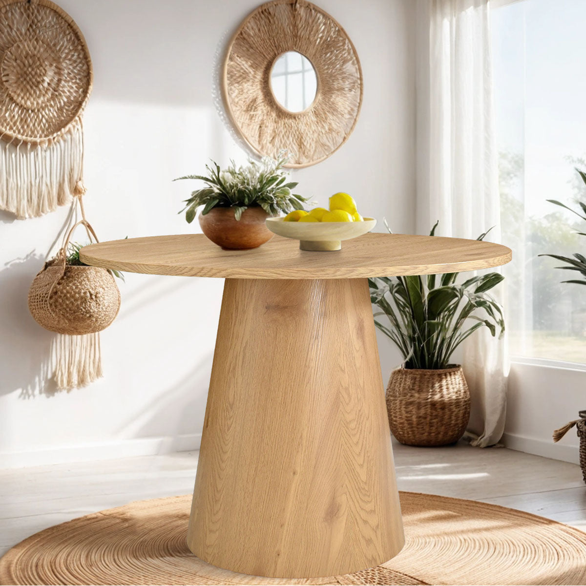 Dwen Modern Round Pedestal Dining Table in cozy dining room with beige walls and woven decor.