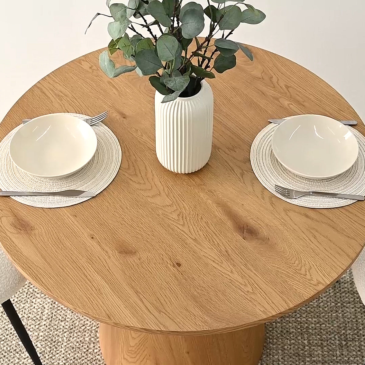 Dwen Modern Round Pedestal Dining Table with neutral decor, beige carpet, minimalist dining setup.