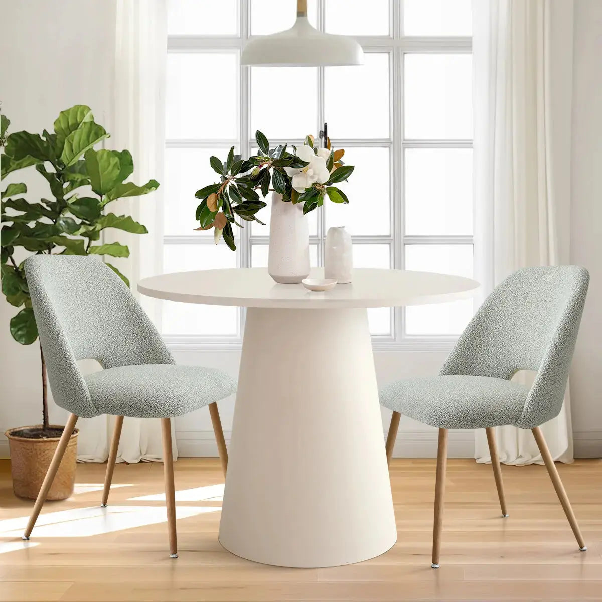 Edwin Modern Upholstered Dining Chair in dining room with light wood flooring and white round table.