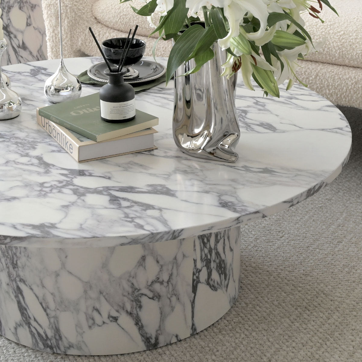 Dwen Modern Marble Round Pedestal Coffee Table in cozy living room with soft beige sofa.