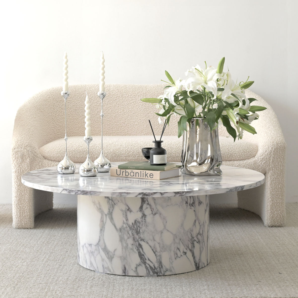 Dwen Modern Marble Coffee Table in living room with white boucle sofa, neutral carpet flooring.