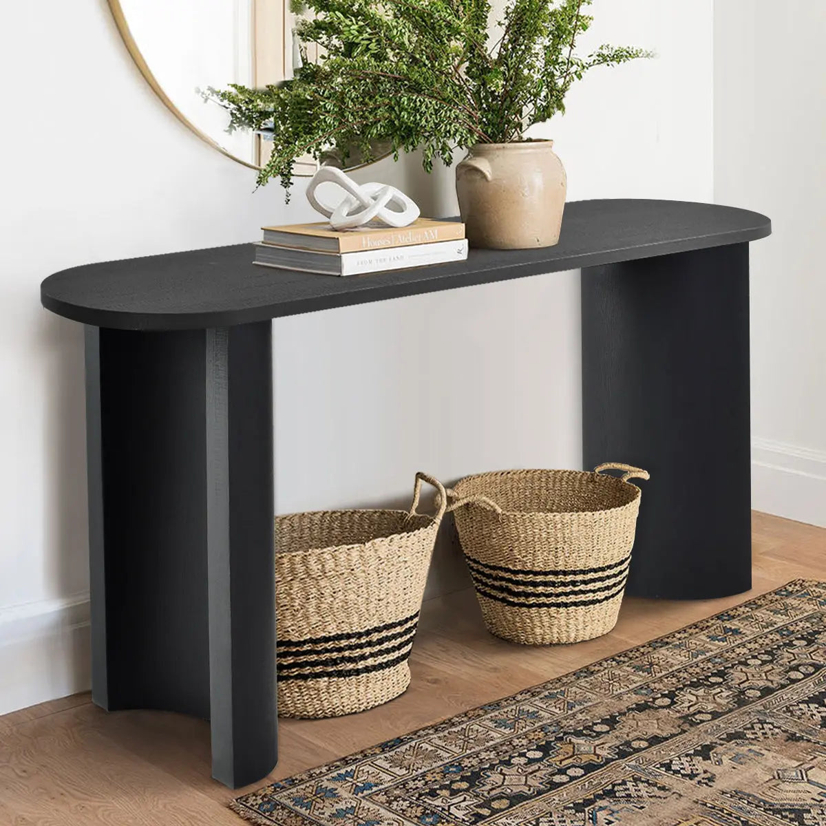 Dwen Modern Oval Console Table in living room, light wall, wood floor, decor basket, patterned rug.