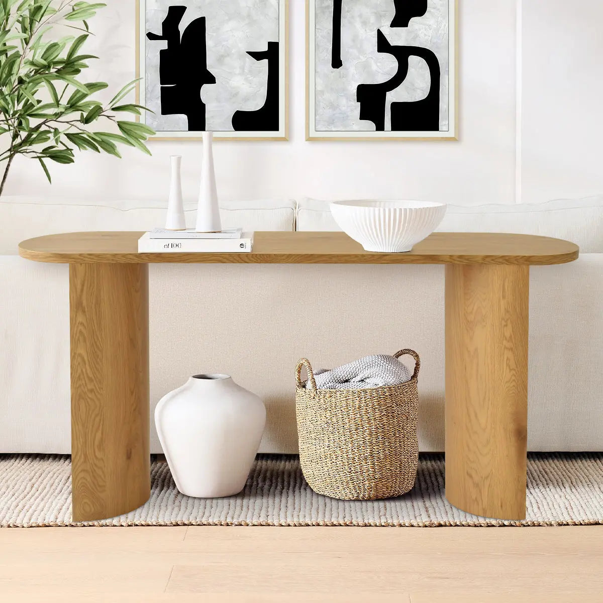 Dwen Modern Oval Console Table in cozy living room with neutral sofa, abstract wall art, light flooring.