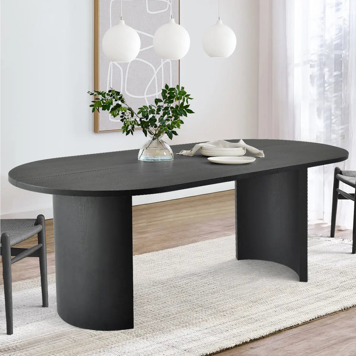 Dwen Modern Large Oval Dining Table with chairs, wooden flooring, white rug, pendant lights.