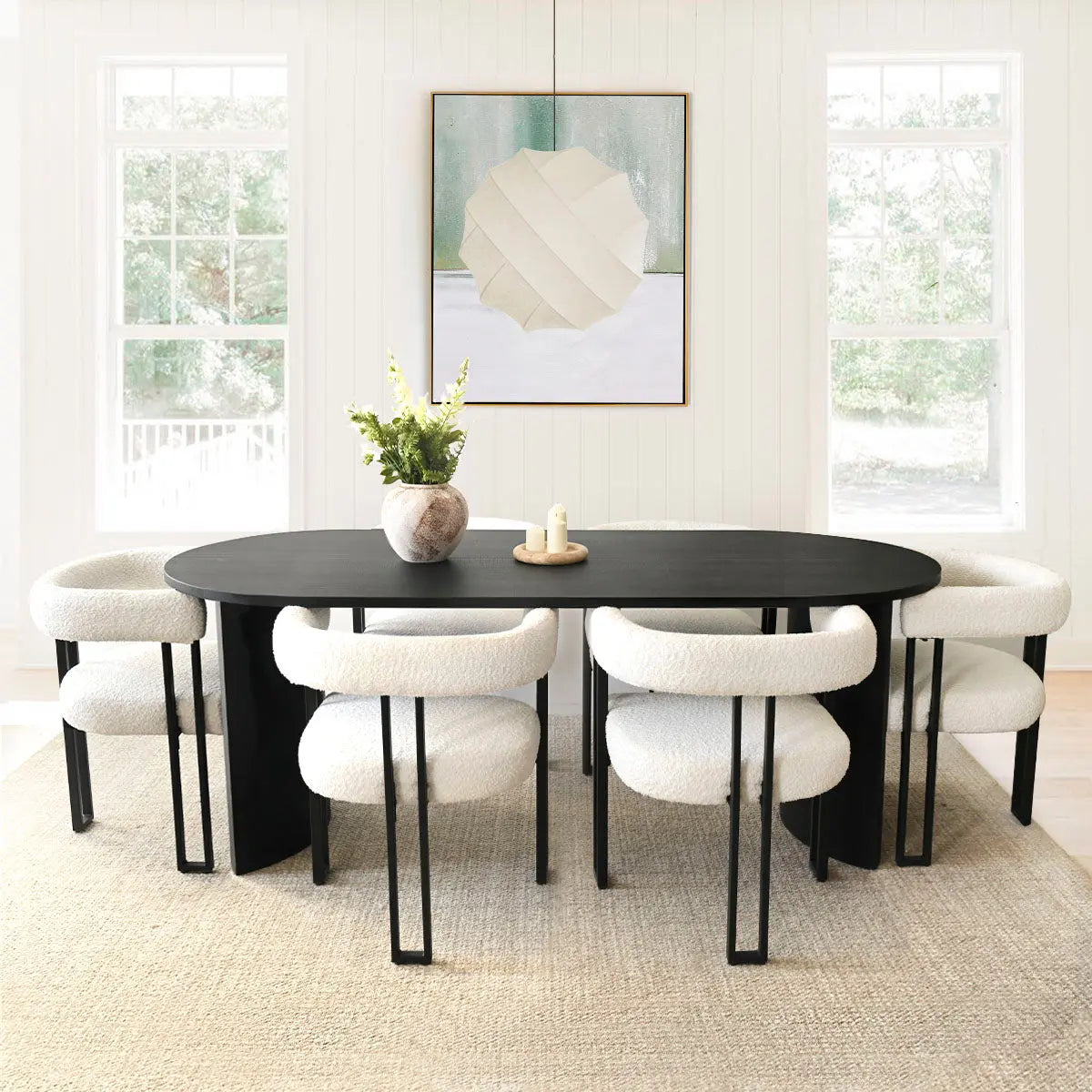 Dwen & Mia 79" oval dining table with beige chairs, modern art, light walls, and rug flooring.