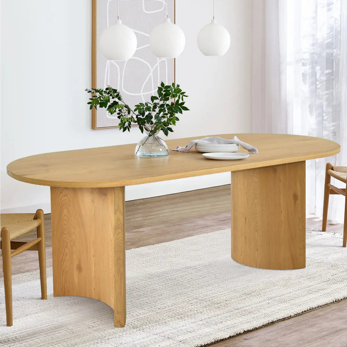 Dwen Modern Oval Dining Table in cozy room with light wood flooring and elegant pendant lights.