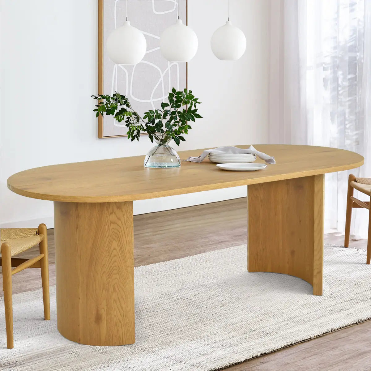 Dwen Modern Large Oval Dining Table, light wood, neutral dining room, wooden chairs, white rug, art.