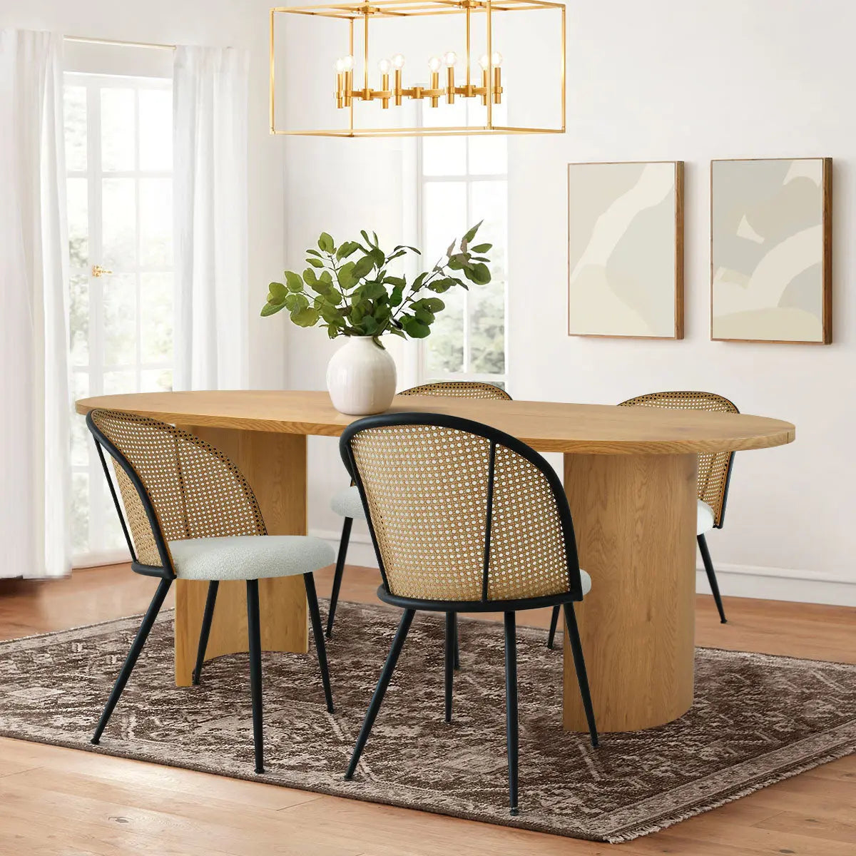 Modern dining room with Dwen Large Oval Dining Table, woven chairs, hardwood floors, and minimalist decor.