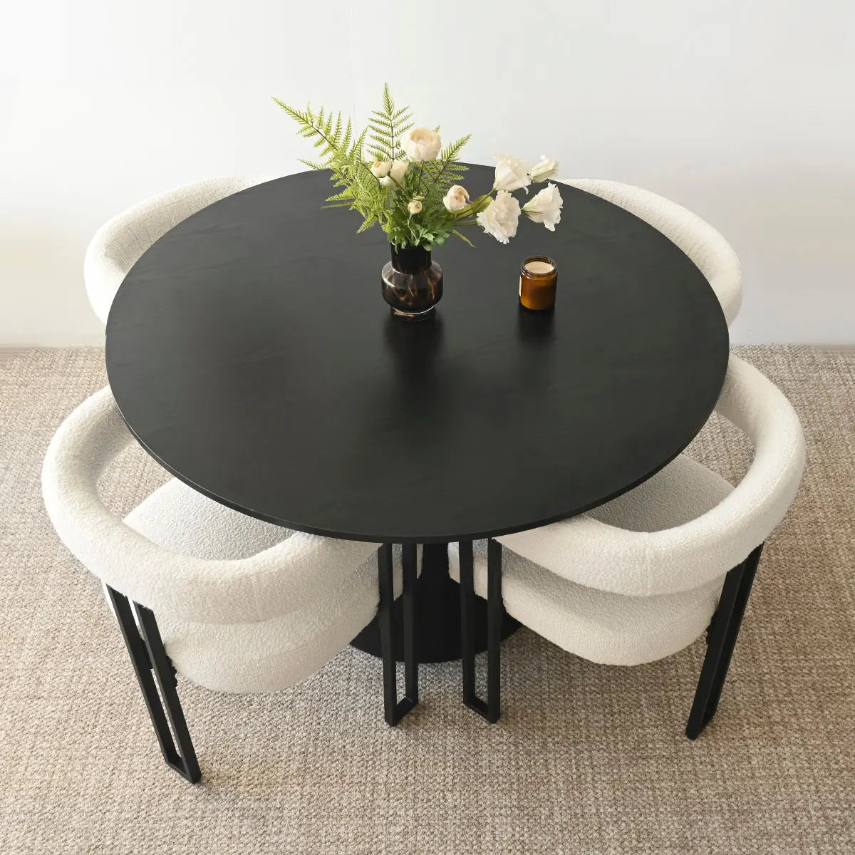 Dwen & Mia dining set, black round table, beige chairs, carpet flooring, modern dining room.