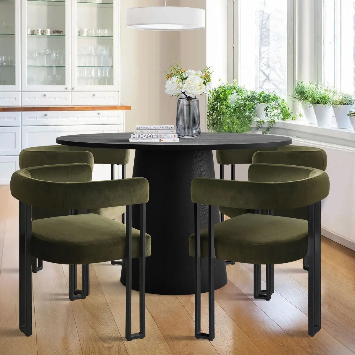 Dwen & Mia dining table set with green velvet chairs, hardwood flooring, white cabinet in dining room.