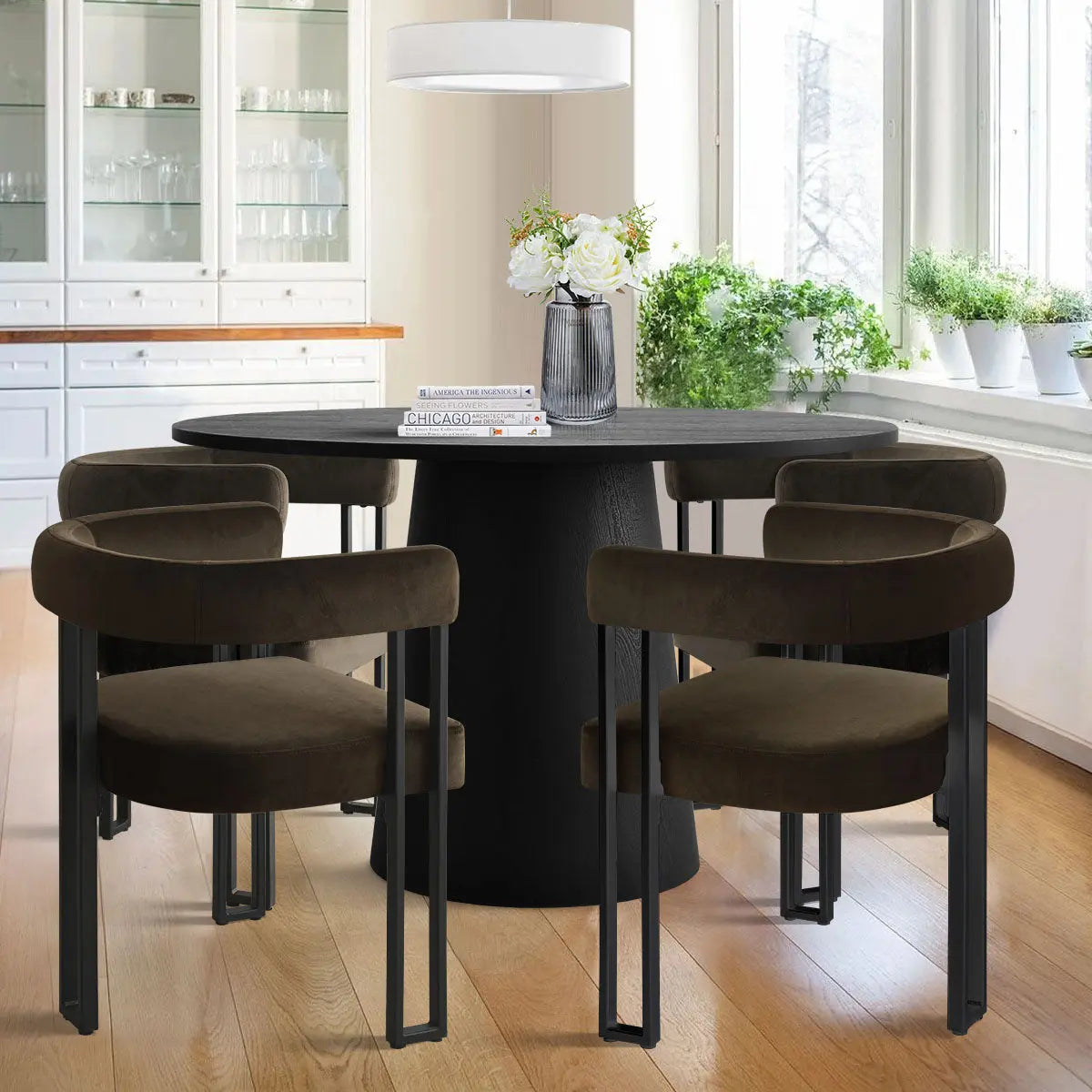 Dwen & Mia black velvet dining table set in bright kitchen with white cabinets, wood flooring.