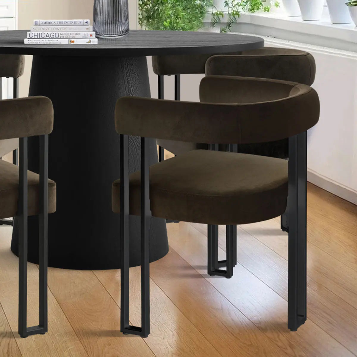 Dwen & Mia dining table set with velvet chairs, wooden flooring, neutral walls, modern dining room.