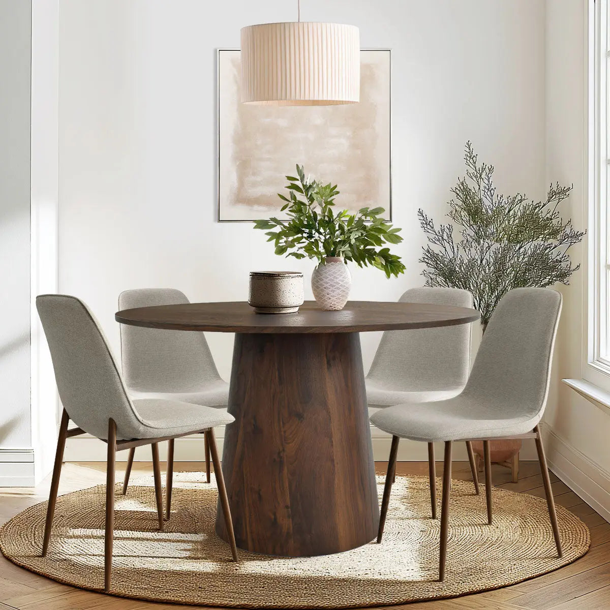 Dwen & Oslo round dining set with wooden table, beige chairs, neutral walls, rug, pendant light.