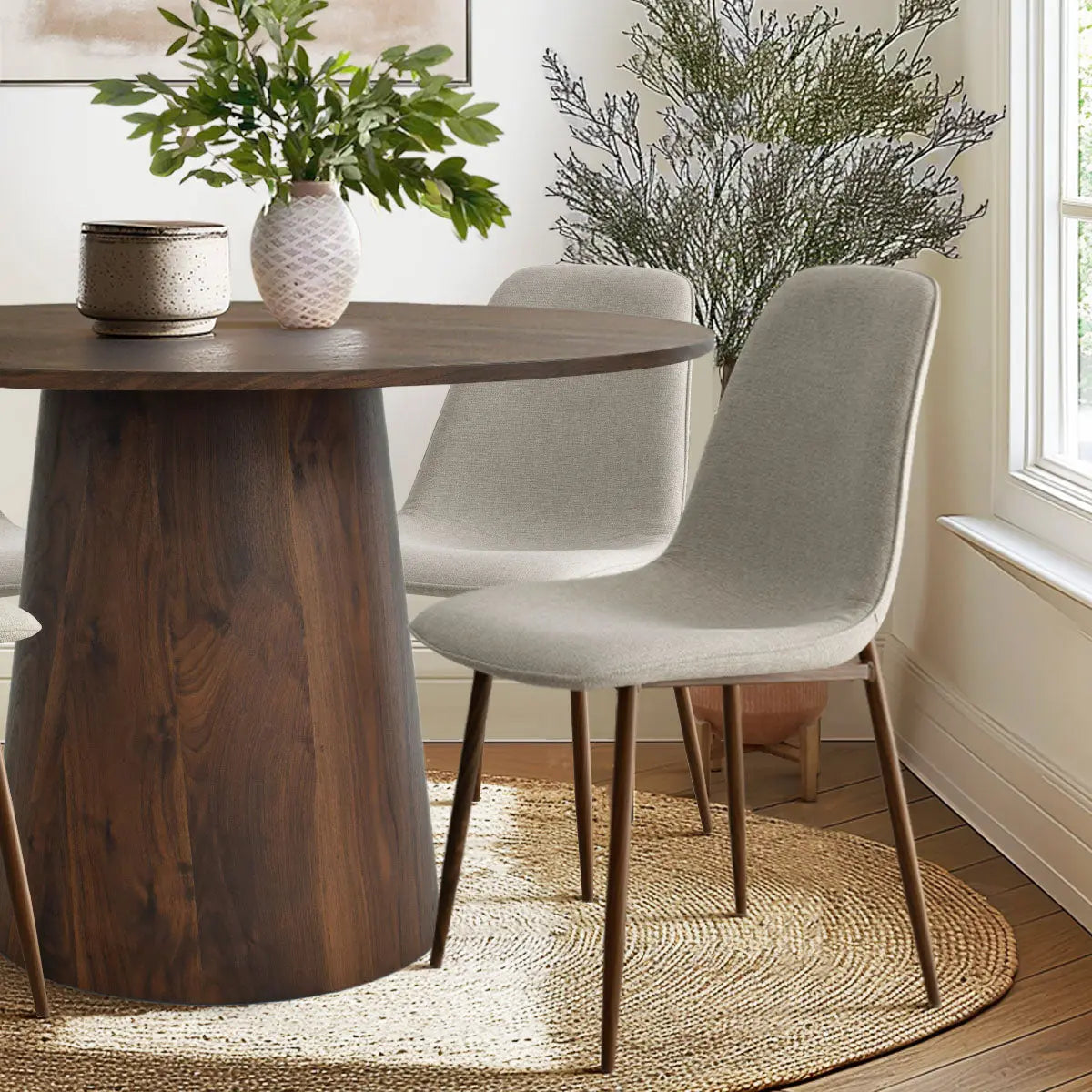 Dwen & Oslo dining set with beige chairs, wood flooring, woven rug, in a contemporary dining room.