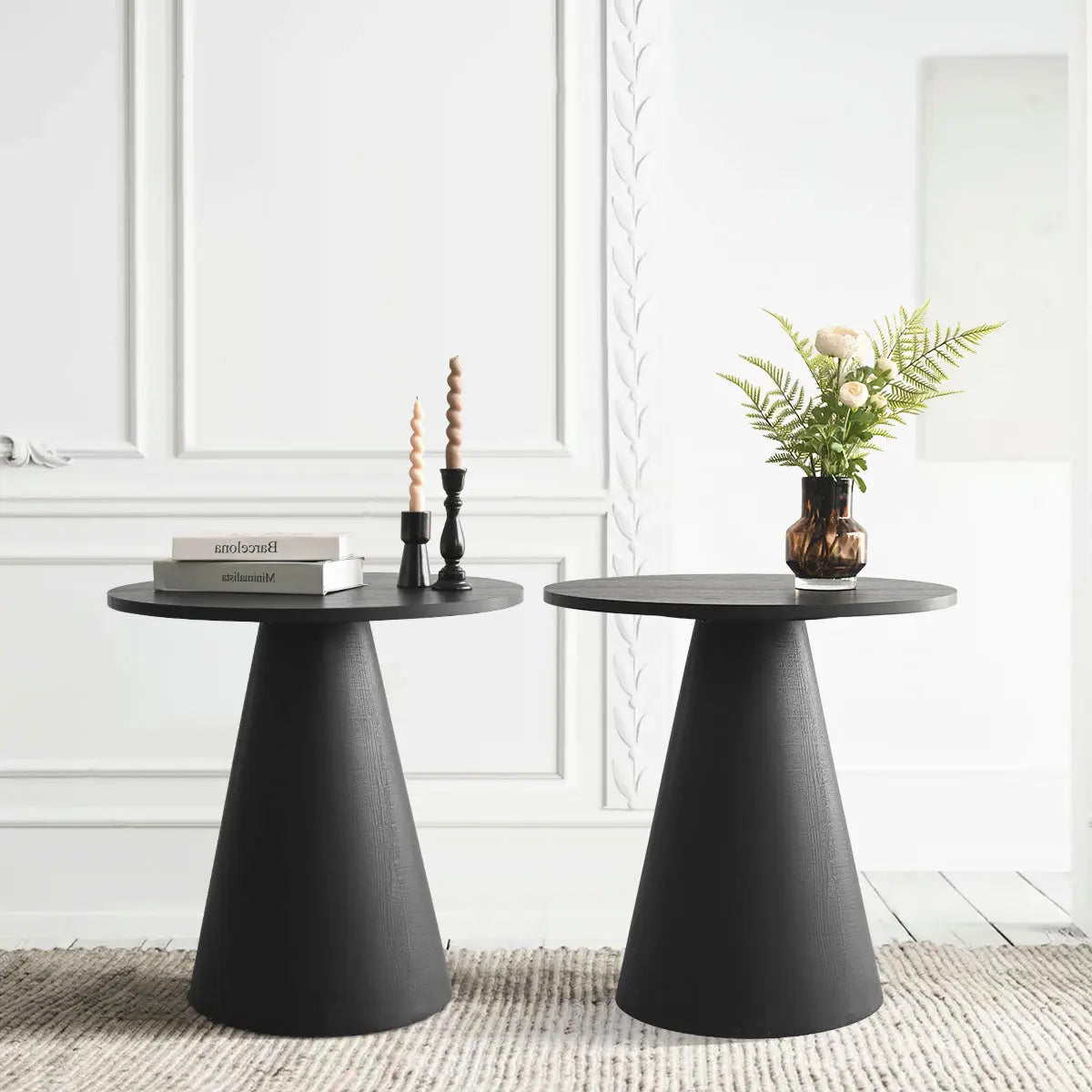 Dwen Modern Black Round Side Table in stylish room with white panel walls and textured carpet.