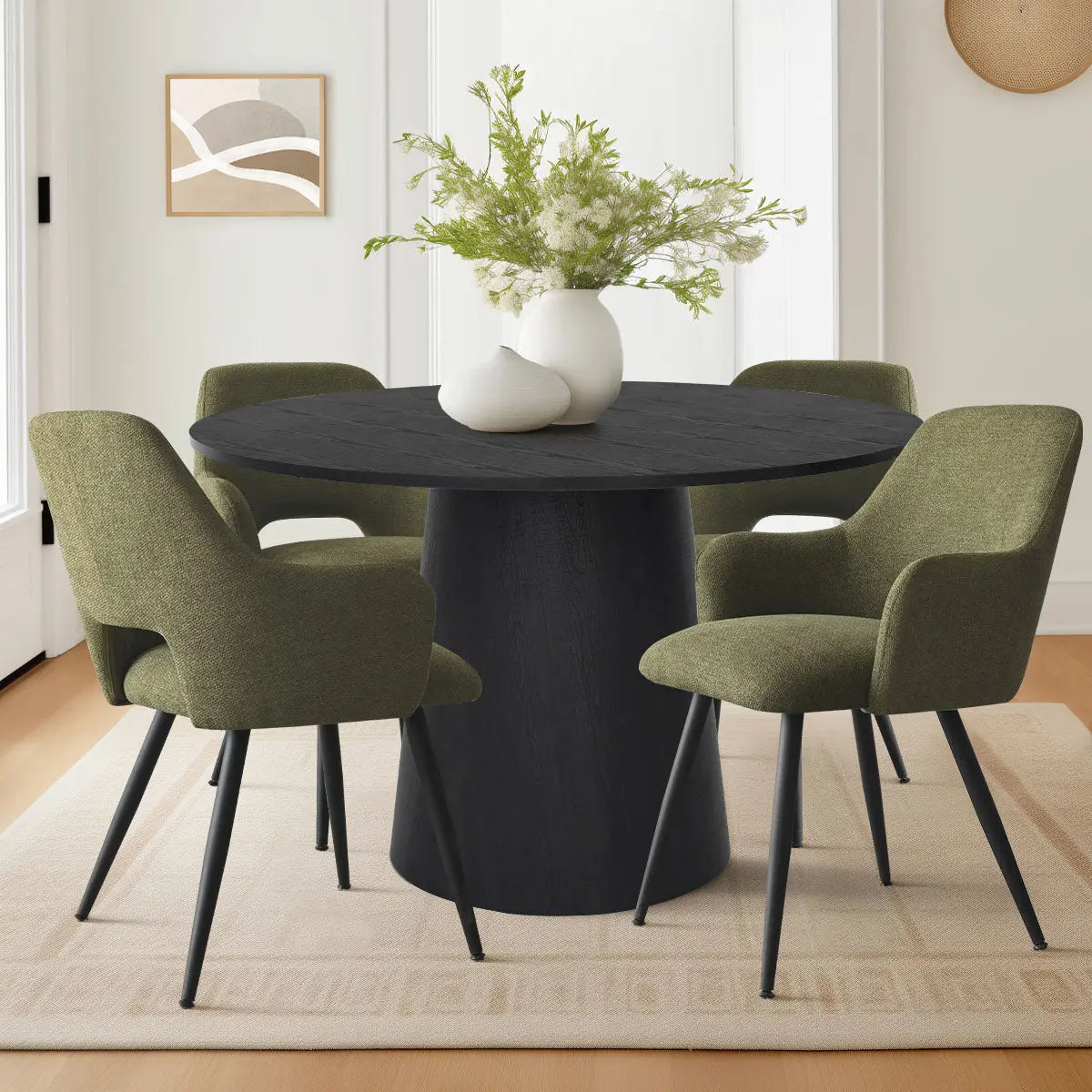 Dwen & Edwin black round dining table set with green chairs in modern dining room.